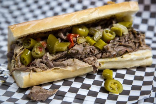 A hearty sandwich filled with shredded beef, jalapeños, and peppers, served on a toasted hoagie roll.