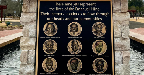 A plaque honoring the Emanuel Nine, featuring their names and images, surrounded by a serene water feature.