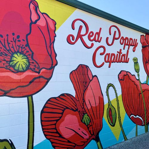 Colorful mural featuring red poppies with the text "Red Poppy Capital" on a vibrant background.