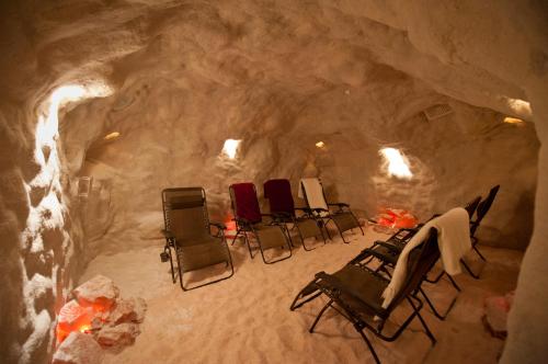 A cozy salt room with reclining chairs and soft lighting, designed for relaxation and wellness.