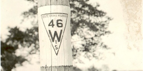 A vintage highway marker for State Trunk Highway 46 in Wisconsin, featuring a triangular design.