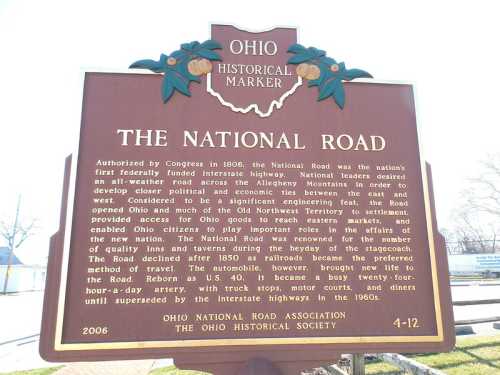 Historical marker for the National Road in Ohio, detailing its significance and development in the early 1800s.