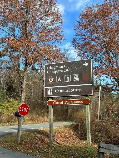 Sign for Dingmans Campground with icons for camping and a general store; a "Closed for Season" sign below.