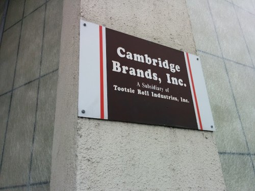 Sign for Cambridge Brands, Inc., a subsidiary of Tootsie Roll Industries, mounted on a building wall.
