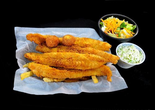 A platter of golden fried fish fillets with hushpuppies, coleslaw, and a side salad.