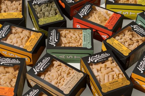 A colorful assortment of pasta boxes from Nicoletto's Pasta Co., featuring various shapes and sizes.