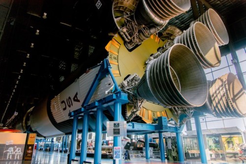 A large rocket engine displayed indoors, showcasing its intricate design and powerful thrusters.