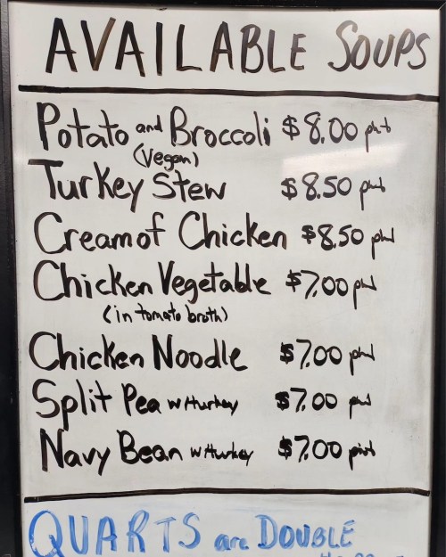 A menu board listing available soups with prices, including options like Potato and Broccoli, Turkey Stew, and Chicken Noodle.