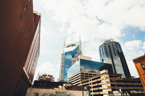A view of Nashville's skyline featuring modern skyscrapers under a partly cloudy sky.