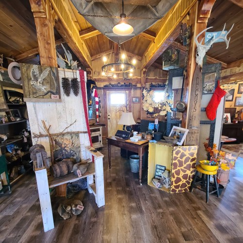 Cozy interior of a rustic shop featuring wooden decor, antiques, and seasonal decorations. Warm, inviting atmosphere.
