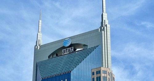 The AT&T building features a distinctive design with two spires against a blue sky.