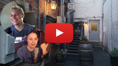 Two people in a video call overlaying a dimly lit alley with stairs and a door, featuring a play button in the center.