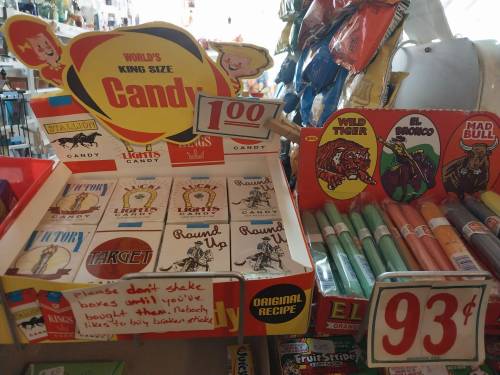 Display of various candy boxes, including "King Size Candy" and "Round Up," with prices marked at 100 and 93 cents.