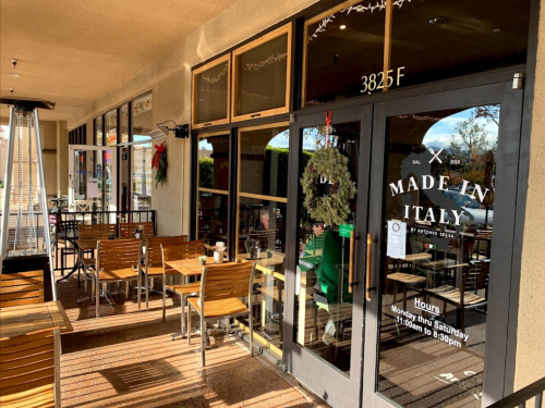 Exterior view of a restaurant named "Made in Italy," featuring outdoor seating and a welcoming entrance.