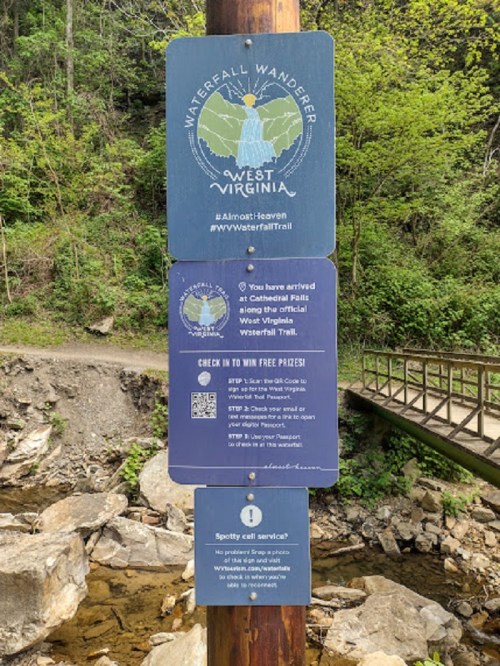 Sign for the Waterfall Wanderer in West Virginia, detailing check-in instructions and trail information.
