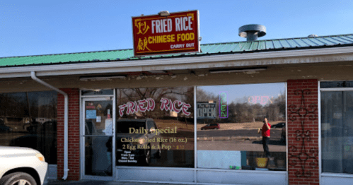 A storefront for "Fried Rice Chinese Food" with a sign indicating it's open and a daily special displayed in the window.