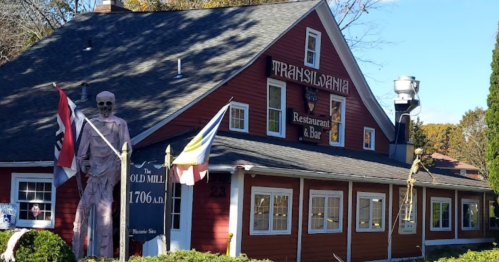 A red restaurant building with a sign reading "Transylvania" and a skeleton decoration outside.
