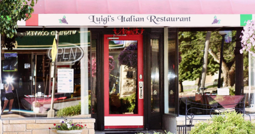 Exterior of Luigi's Italian Restaurant featuring a red door and a sign with the restaurant's name.