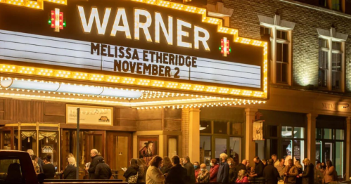 Crowd gathered outside the Warner Theatre, illuminated marquee announcing Melissa Etheridge on November 2.