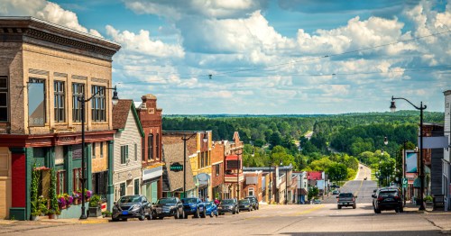 View looking down a picturesque Michigan street from atop a hill.