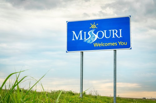 Missouri Welcomes You” roadside sign featuring the state outline