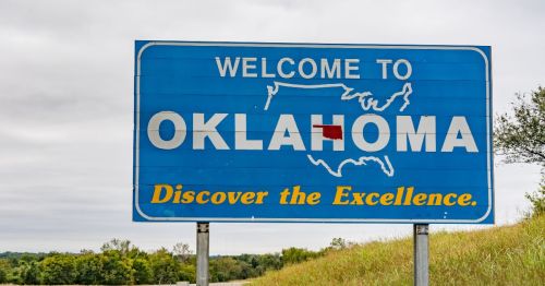 Close up of the Oklahoma welcome road sign on a cloudy day