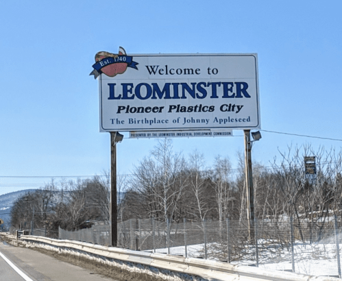Welcome sign for Leominster, Massachusetts, highlighting its history as the birthplace of Johnny Appleseed.