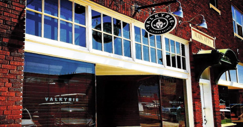 Exterior of a brick building featuring large windows and a sign for "Valkyrie" above the entrance.
