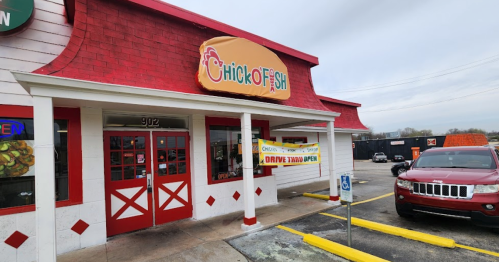 Exterior of Chick O Fish restaurant with a red roof, sign, and a banner announcing drive-thru service.