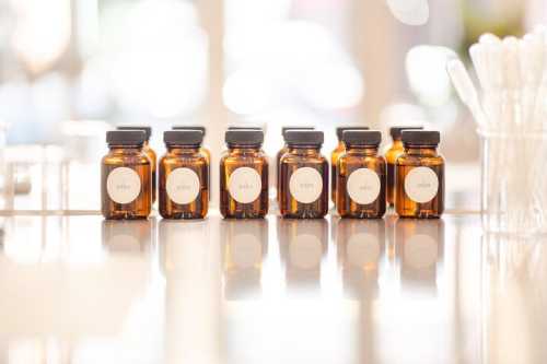 Seven amber glass bottles lined up on a table, each labeled with a different year from 2010 to 2016.