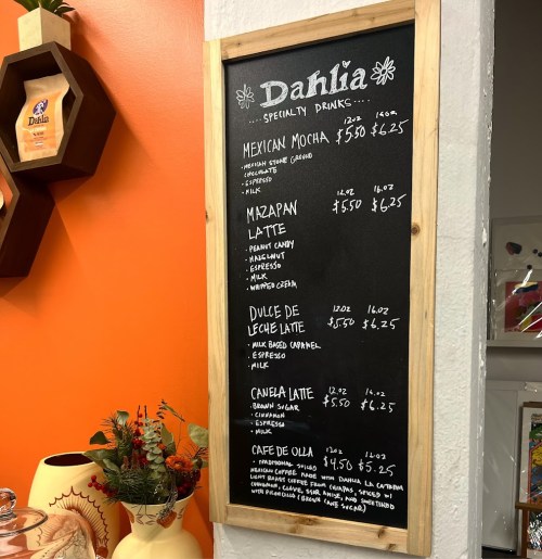 Chalkboard menu featuring specialty drinks like Mexican Mocha, Mazapan Latte, and Dulce de Leche Latte at Dahlia.