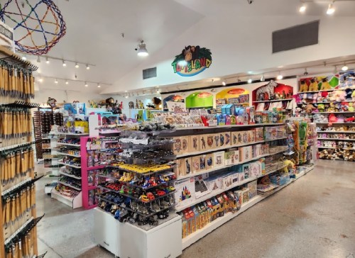 A colorful toy store aisle filled with shelves of toys, games, and stuffed animals, creating a vibrant shopping atmosphere.