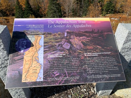 Sign about the Appalachian Trail, featuring a map, trail information, and scenic background of autumn foliage.