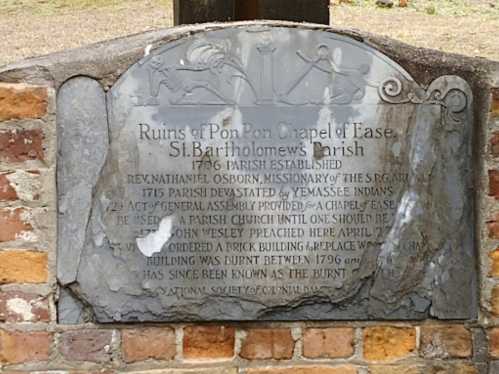 Historical plaque detailing the ruins of Pon Pon Chapel of Ease, St. Bartholomew's Parish, with information on its history.