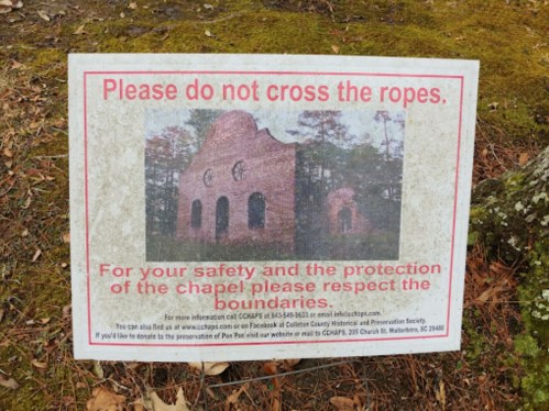 Sign warning against crossing ropes, emphasizing safety and respect for the chapel's boundaries.