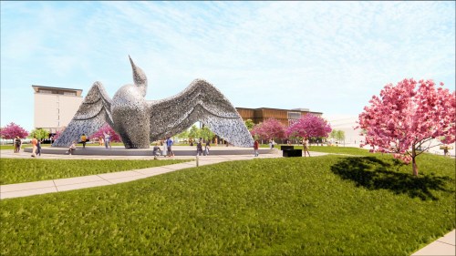 A large metallic sculpture of a bird with outstretched wings, surrounded by blooming cherry trees and people walking.