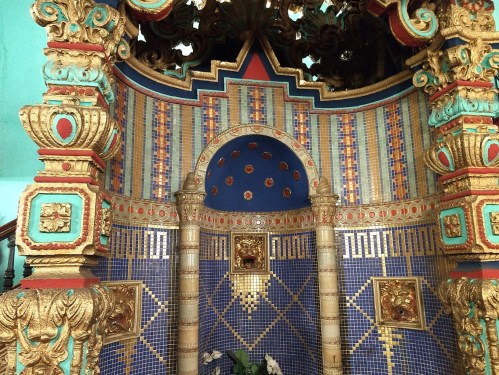 Ornate architectural detail featuring colorful tiles, intricate carvings, and a decorative archway.