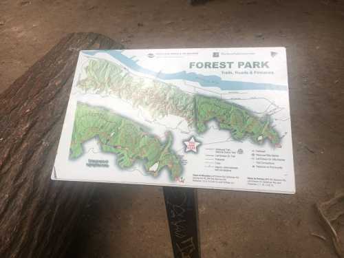 Map of Forest Park showing trails, roads, and features, with a river and surrounding landscape in the background.