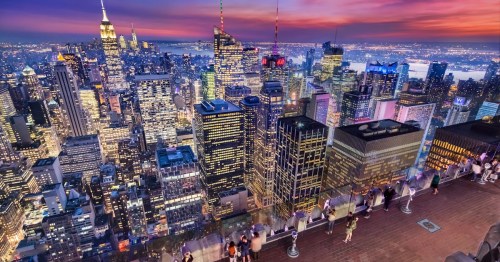 A vibrant city skyline at sunset, featuring skyscrapers and a bustling atmosphere in New York City.