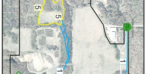 Map showing numbered areas and paths in a wooded landscape, with highlighted sections and labels for navigation.
