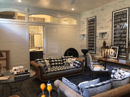 Cozy living room with checkered sofas, a wooden table, and decorative wall art, featuring a warm, inviting atmosphere.