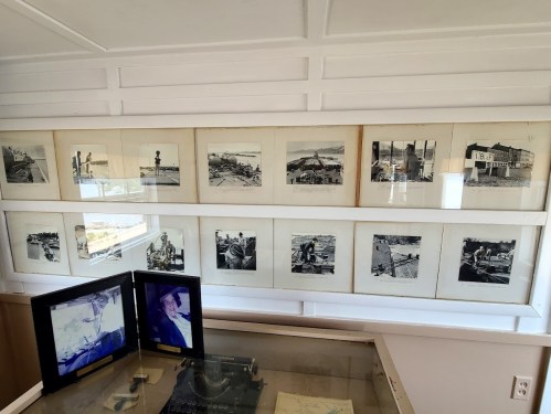A series of black-and-white photographs displayed in a frame, showcasing various historical scenes and activities.