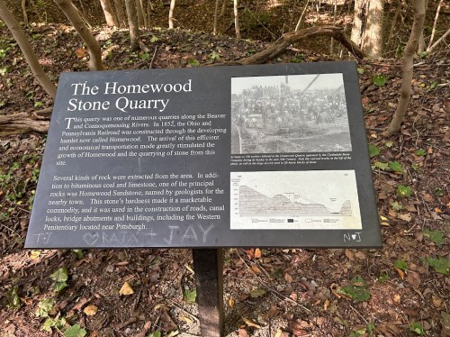 Sign about the Homewood Stone Quarry, detailing its history and significance near the Beaver and Connoquenessing Rivers.