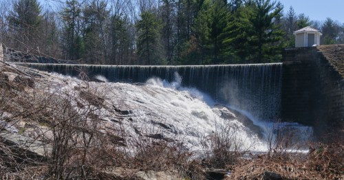 Water cascades down the rocky lower face of waterfall at Barden Reservoir in Rhode Island.