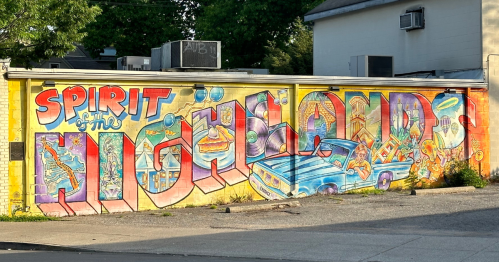 Colorful mural featuring the text "Spirit of the Highlands" with vibrant designs and a classic car illustration.