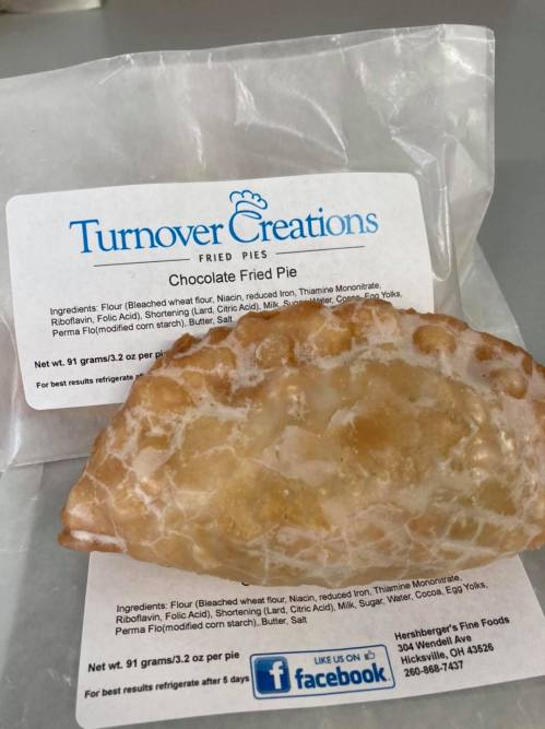 A chocolate fried pie on a white background, with a label listing ingredients and nutritional information.