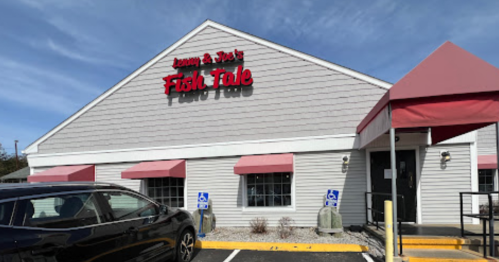 Exterior of a restaurant named "Jimmy & Joe's Fish Tale," featuring a peaked roof and pink awnings.
