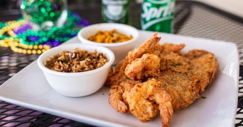 A plate of fried shrip with a side of dirty rice from a Cajun restaurant in Alabama.