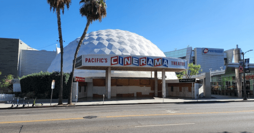 Exterior of Pacific's Cinerama Theatre, featuring a dome structure and bold signage, with palm trees in the foreground.