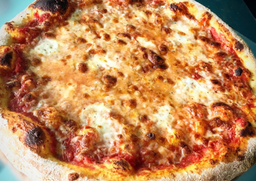 A freshly baked pizza with a golden crust, melted cheese, and a rich tomato sauce.